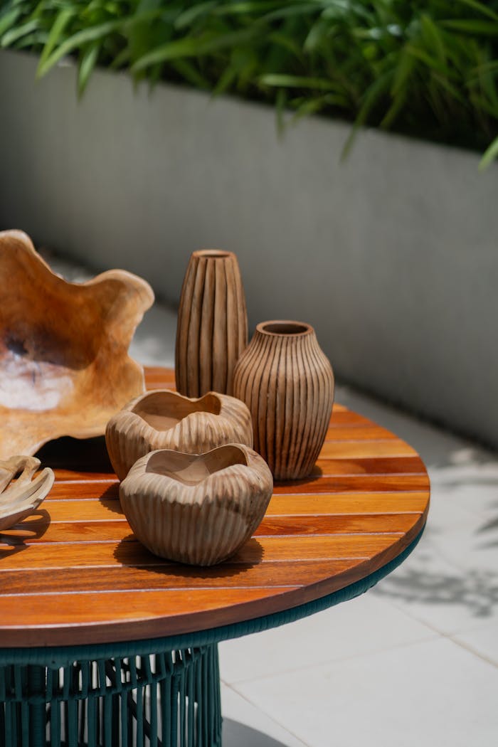 Stylish wooden vases displayed on a rustic table with a natural look.