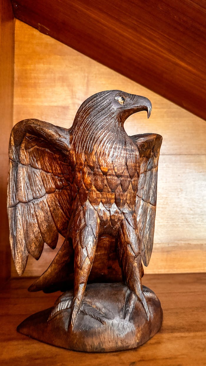 Detailed hand-carved wooden eagle sculpture in Bali, Indonesia showcasing exquisite craftsmanship.